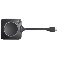 Ein kreisförmiges, schwarzes USB-Gerät mit 'Barco'-Logo; dient zur kabellosen Bildschirmübertragung.